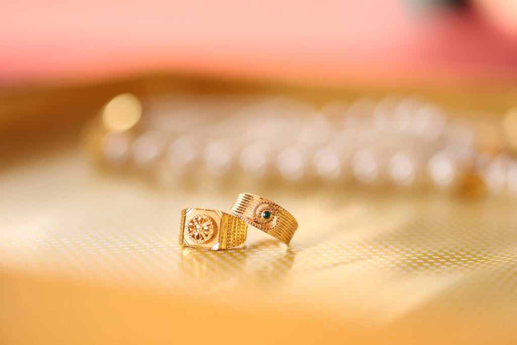 Close-up of gold rings on a textured surface, capturing elegance and sophistication.