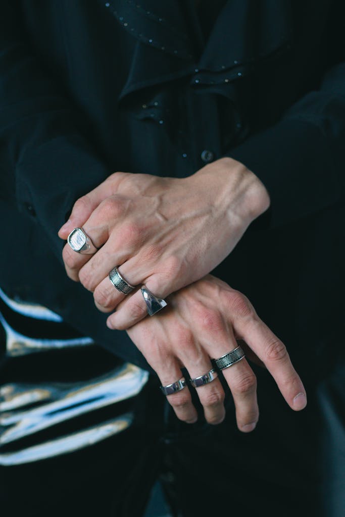 Close-up of male hands displaying silver rings, showcasing a fashionable and stylish look