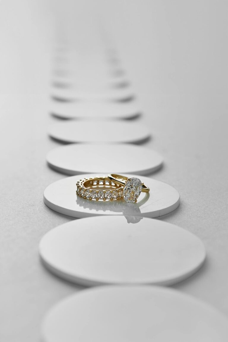 Luxury gold and diamond ring showcased on a minimalist background, highlighting elegance and sophistication.