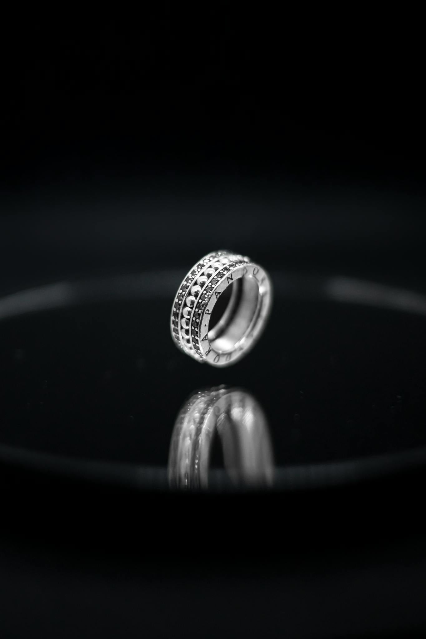 Stylish diamond ring with black background symbolizing elegance and luxury.